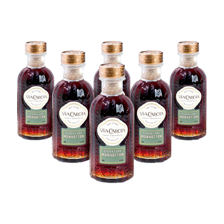 Set of six bottles of Via Caracca Manhattan cocktail mix on a white background