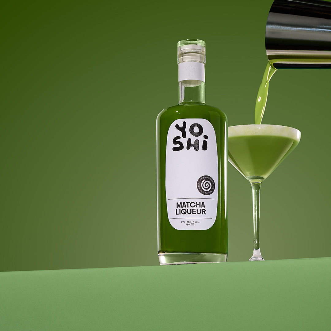 Bottle of Yoshi Matcha Liqueur with a poured glass on a green background